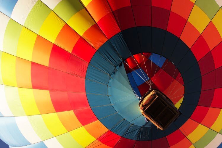 A large and colorful hot air balloon seen from below. 