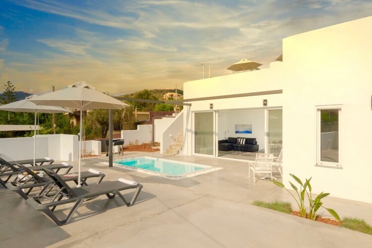 Small white villa with pool and sun lounger