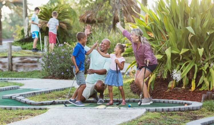 A family celebrating a hole-in-one. 