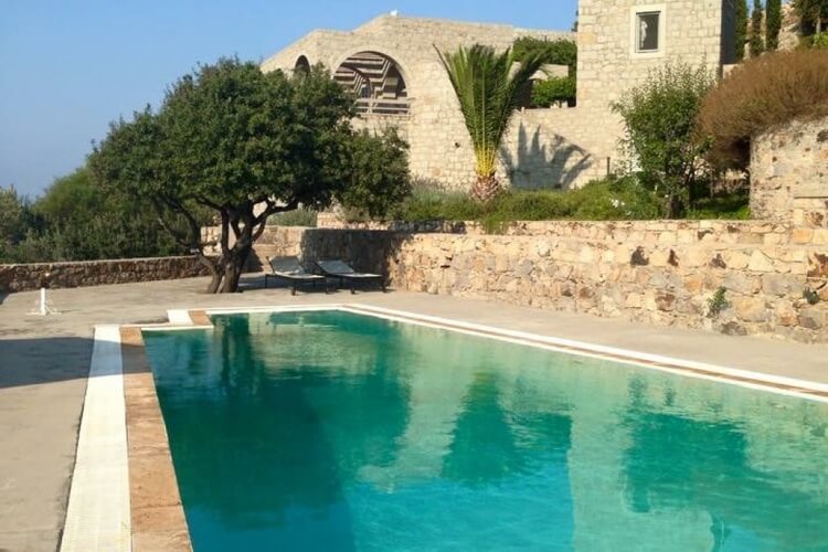 Rustic villa made of stone, large pool, some trees, sun lounger