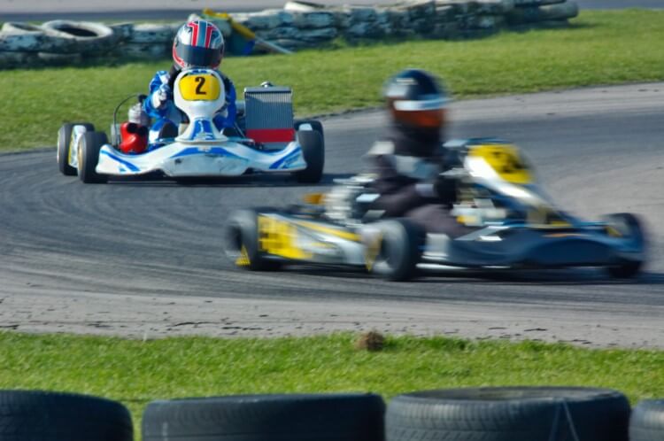 A colorful racer banking around a go-kart track.